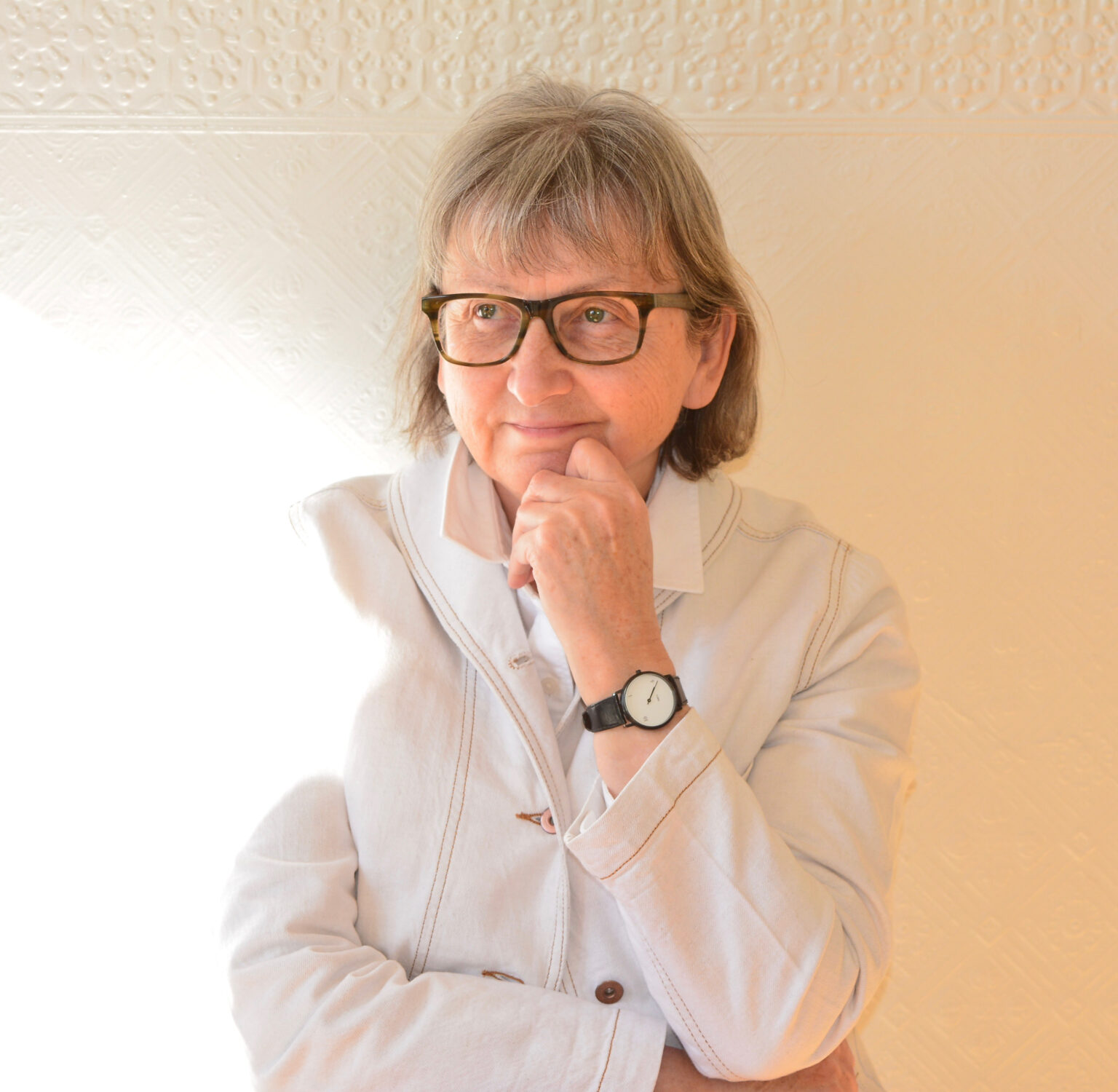 A portrait of a person against a light background.