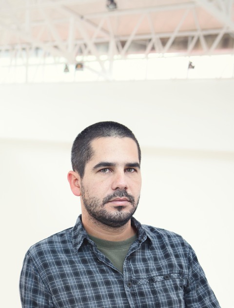 A portrait of a person against a light background.