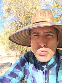 A portrait of a person outside with a tree in the background.