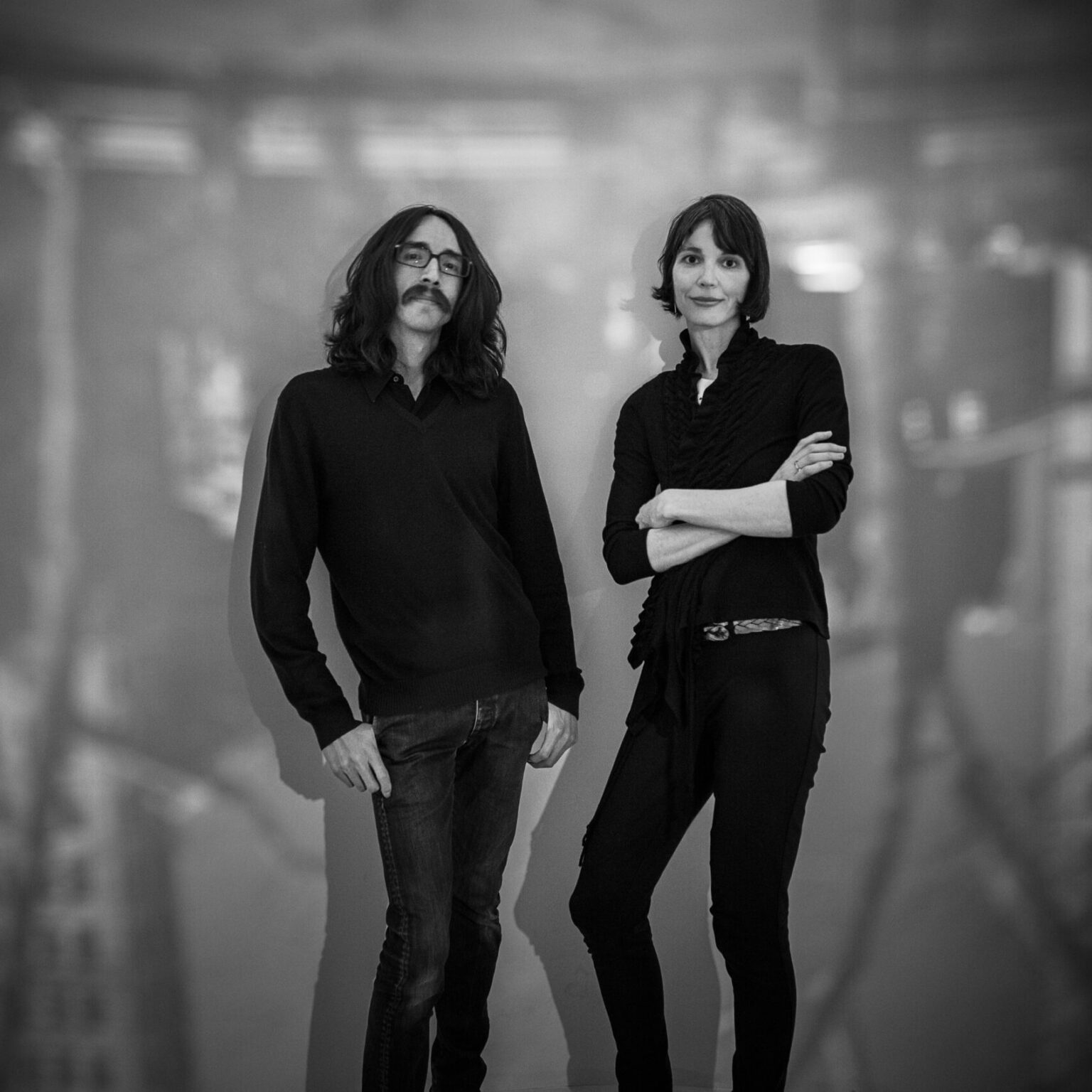 Two people in front of a projected backdrop.