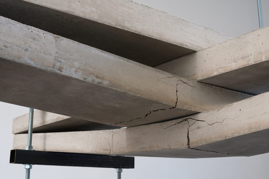 Cracking concrete slabs supported by braces.