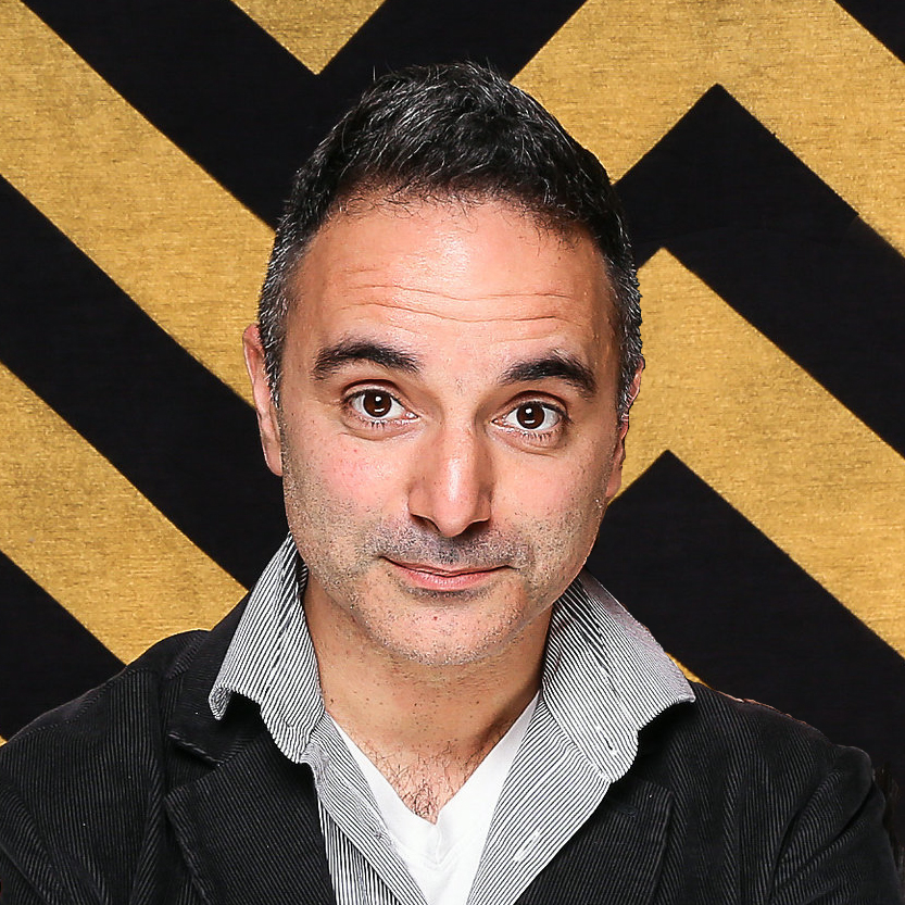 A portrait of a person against a black and yellow geometric background.
