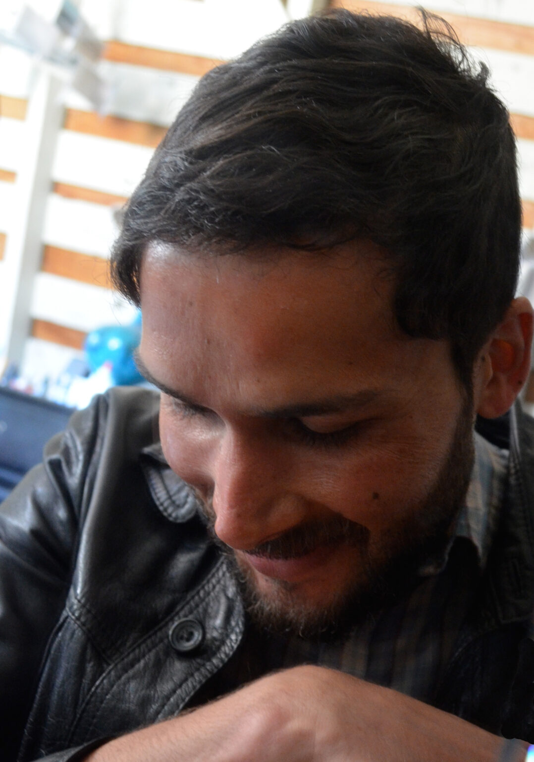 A portrait of a person looking down.