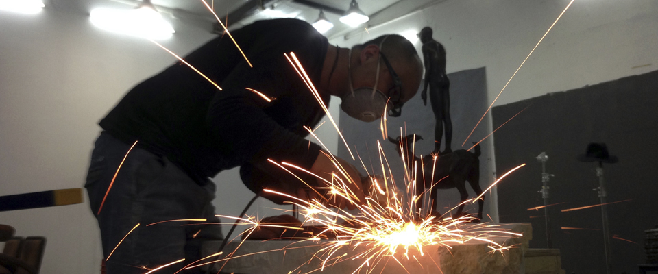 A person using a grinder and causing sparks.