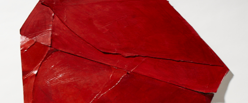 A red sculpture against a white background.