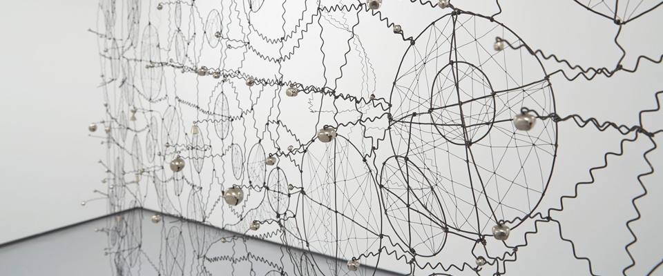 An image of a woven installation in a gallery.