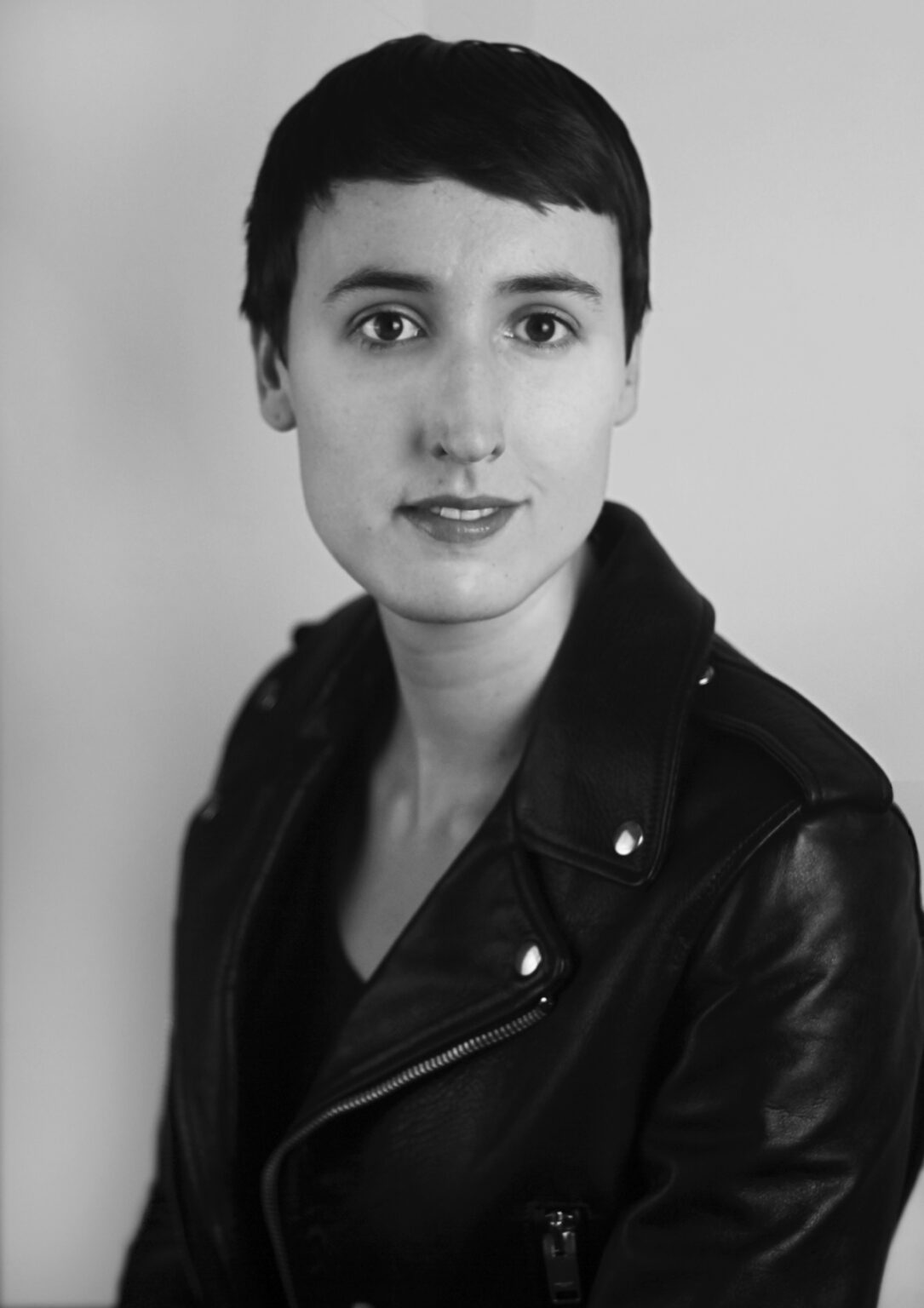 A portrait of a person against a light background.