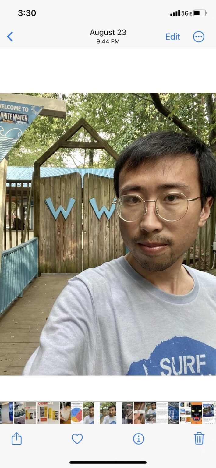 Portrait of Kunlin wearing glasses and a grey t-shirt.