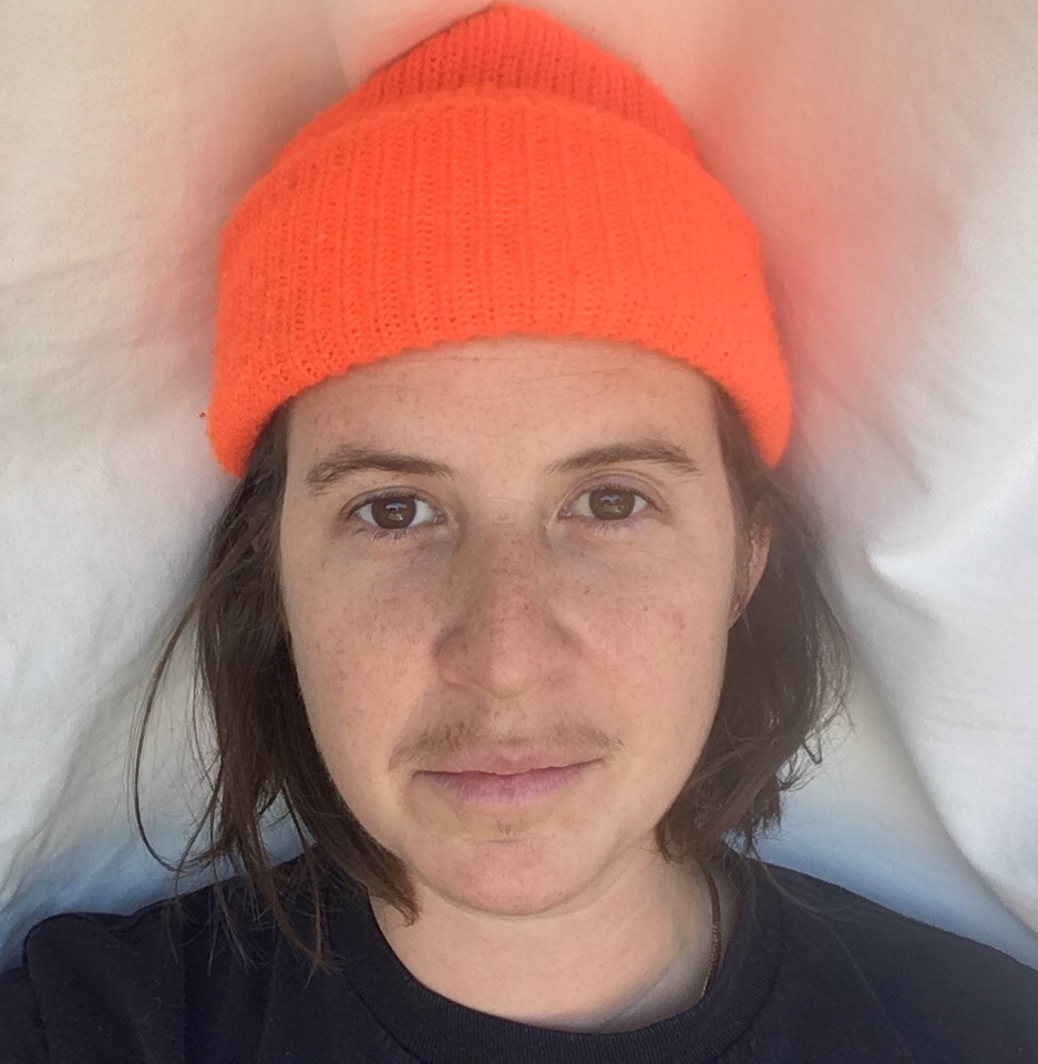 A portrait of a person against a light background.