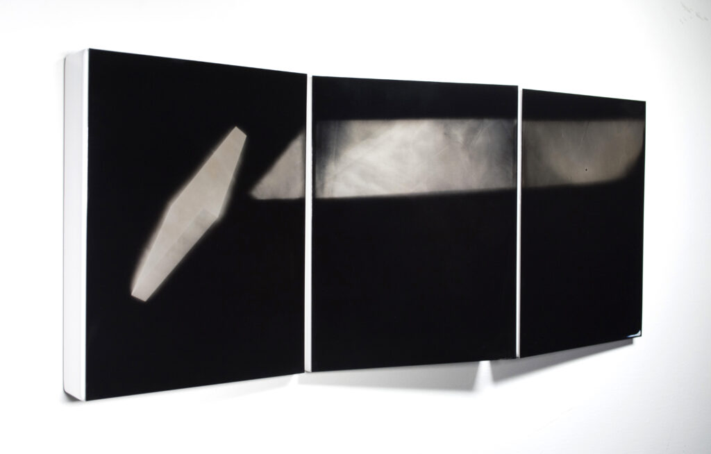 An triptych mounted on a wall.