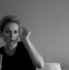 A person raising their hand to their ear.