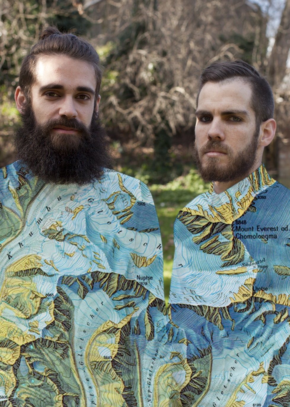 Two people outside wearing clothing printed with a map.