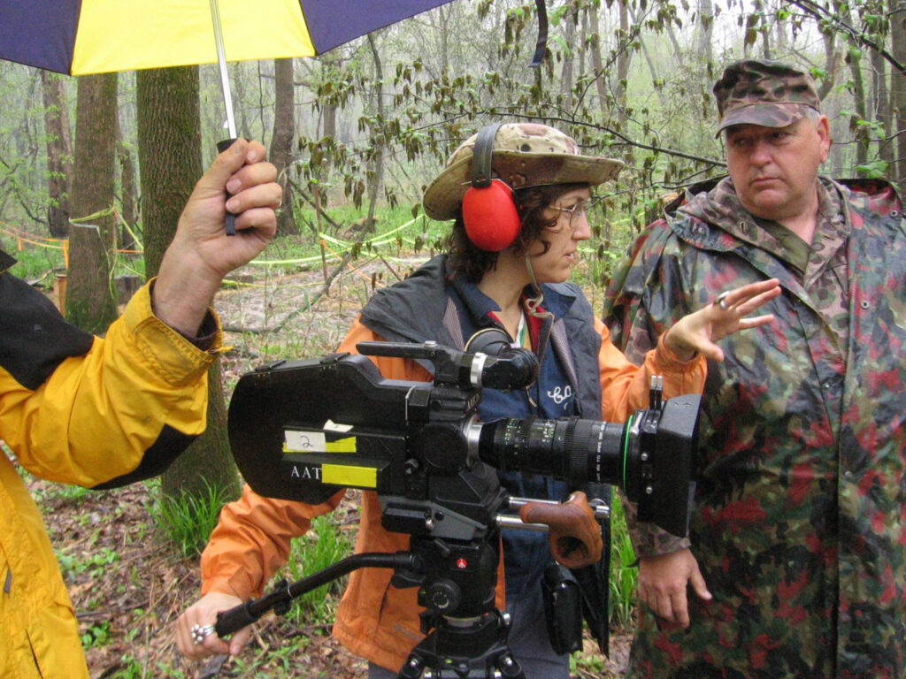 A group of people outside with film equipment.