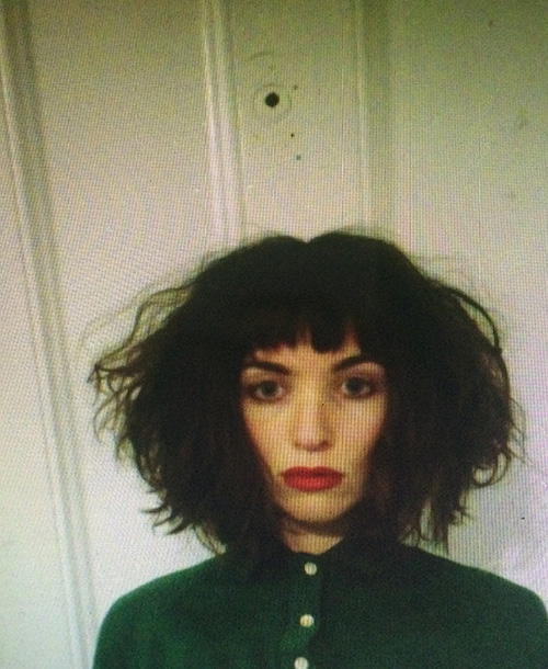 A portrait of a person against a light background.