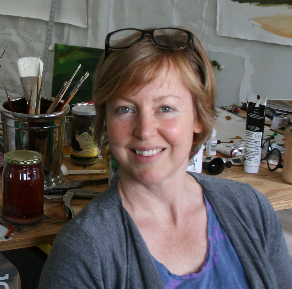 A portrait of a person in an art studio.