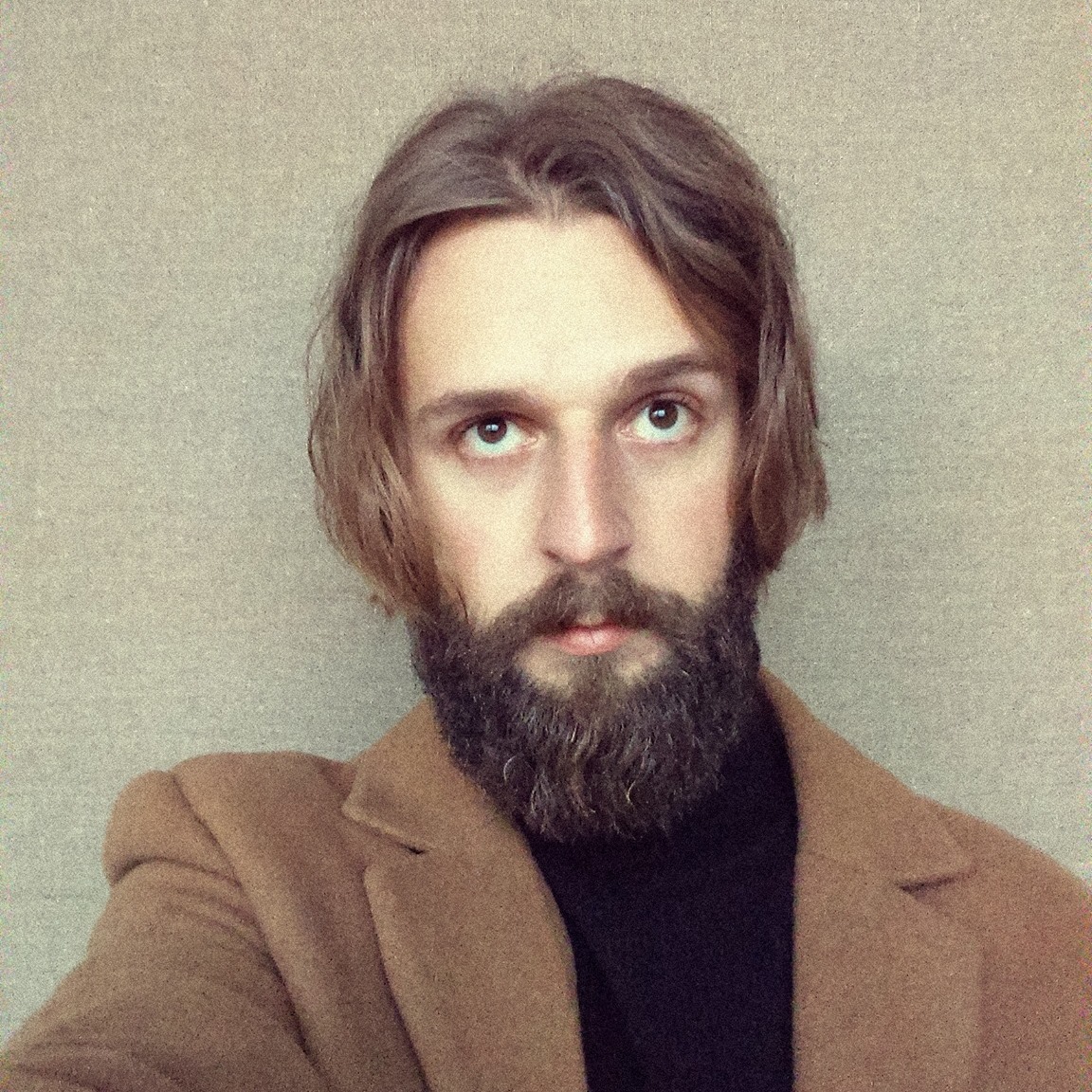 A portrait of a person against a light background.