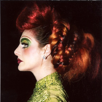 A profile portrait of a person against a dark background.