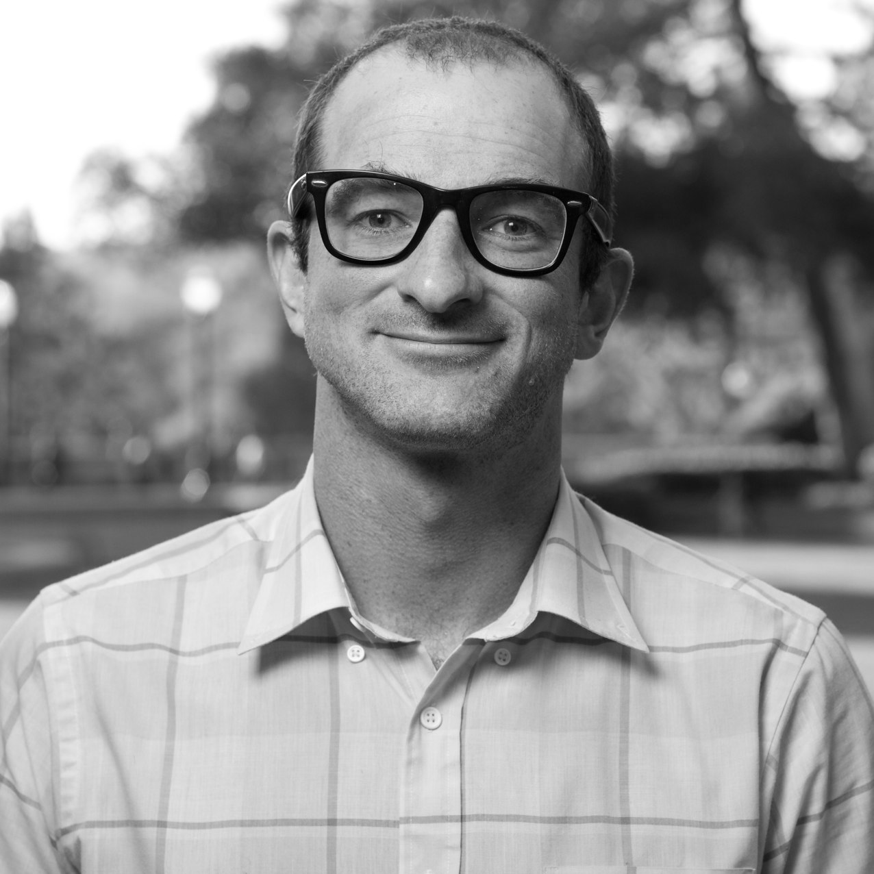 A portrait of a person outdoors.