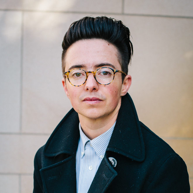 A portrait of a person sitting.