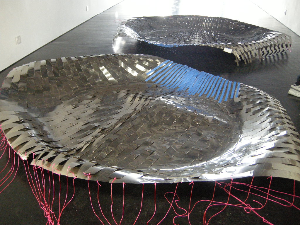 An image of woven metal sculptures.