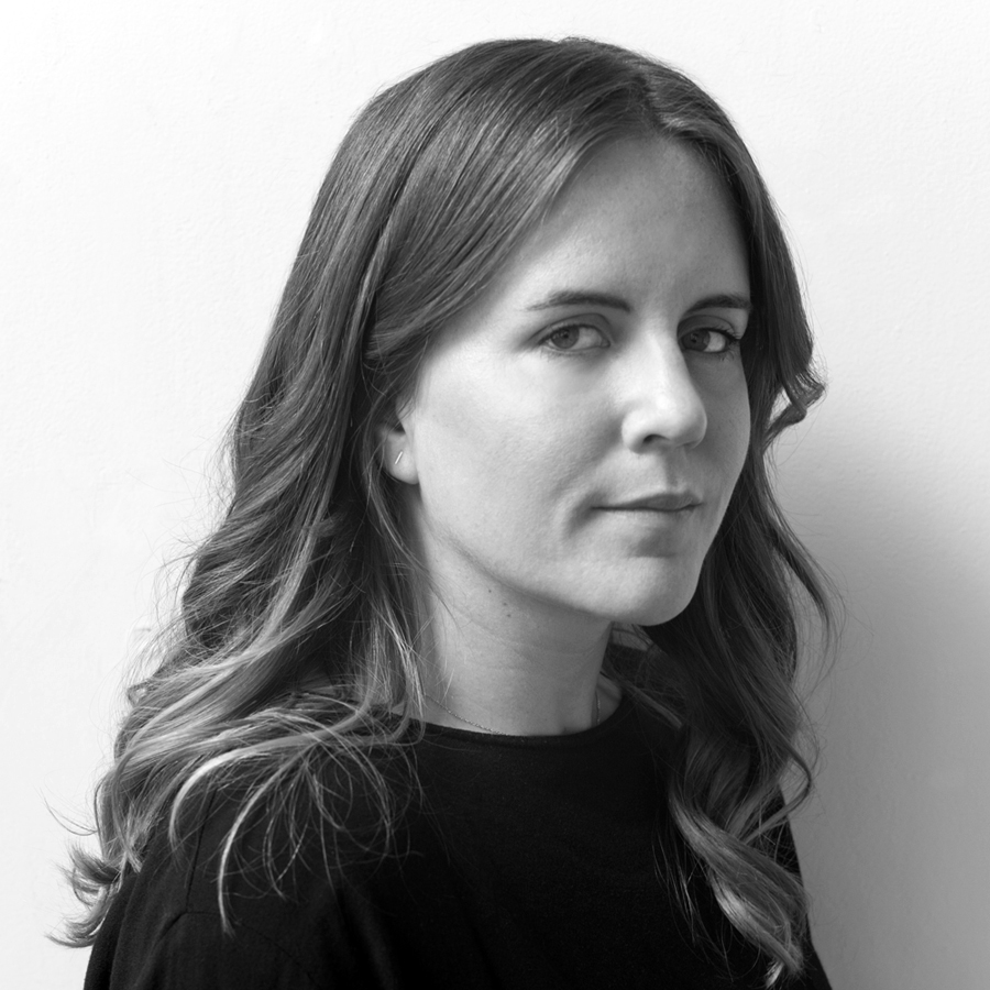 A portrait of a person against a light background.