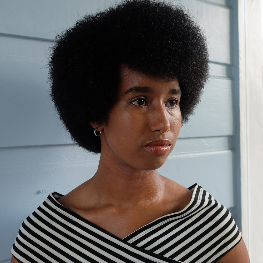 A portrait of a person against light background.