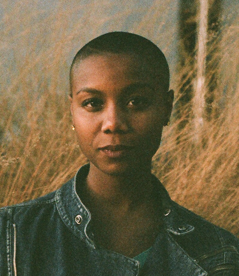 A portrait of a person outdoors.