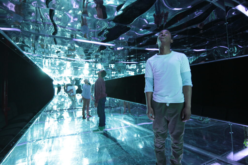 People in a mirrored room.
