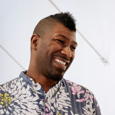 A portrait of a person against a light background.