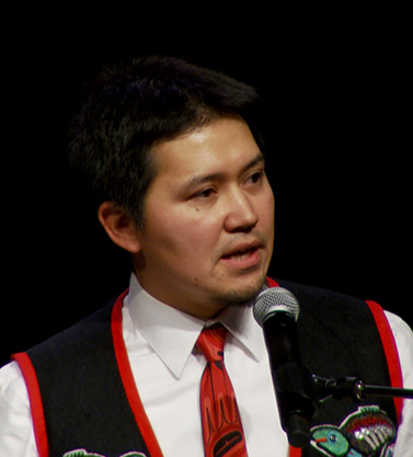 A person speaking into a microphone.