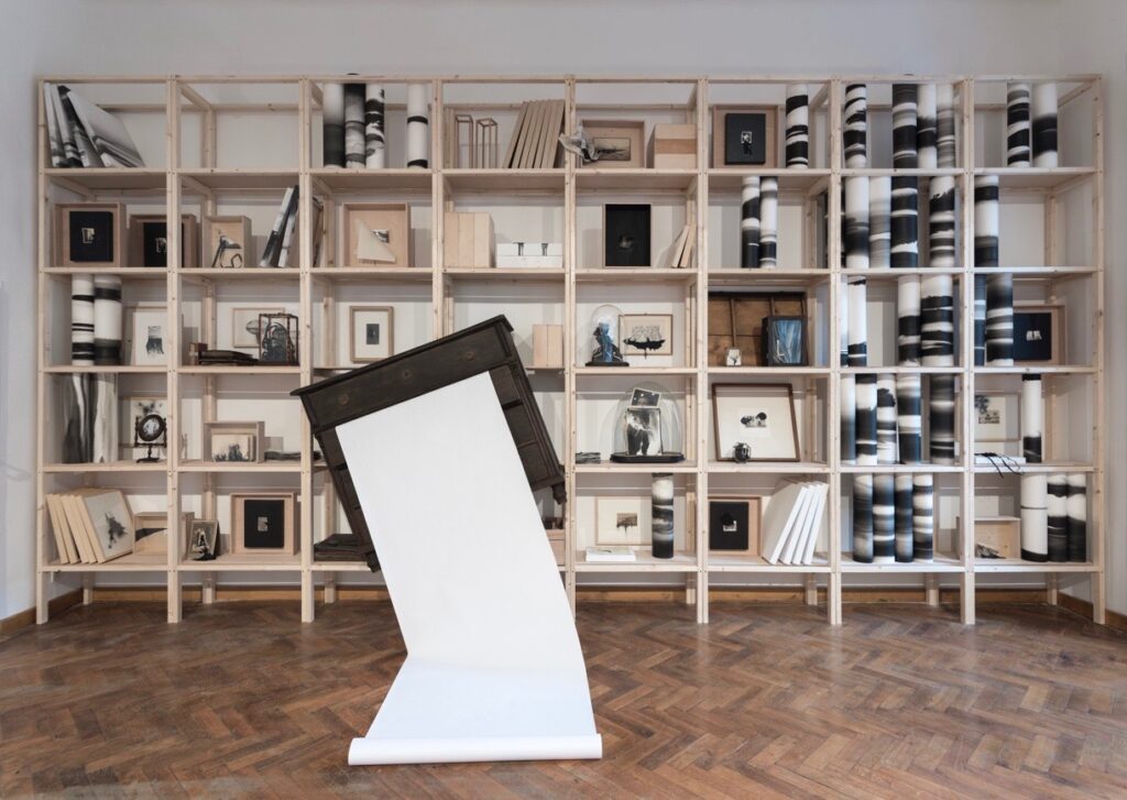 An installation with shelves full of objects.