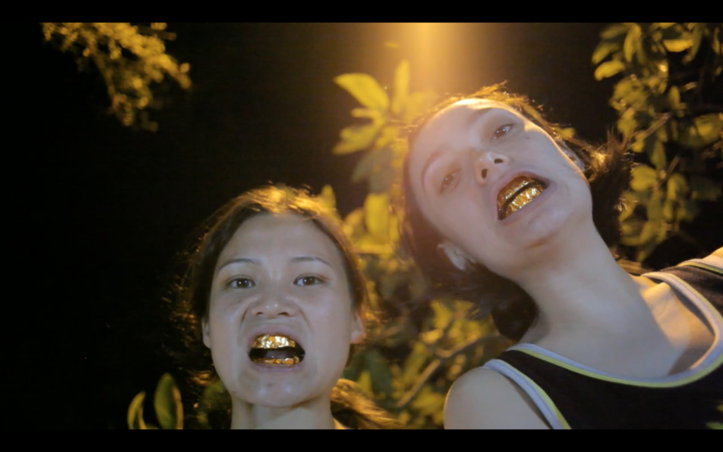 film still with girls with gold teeth