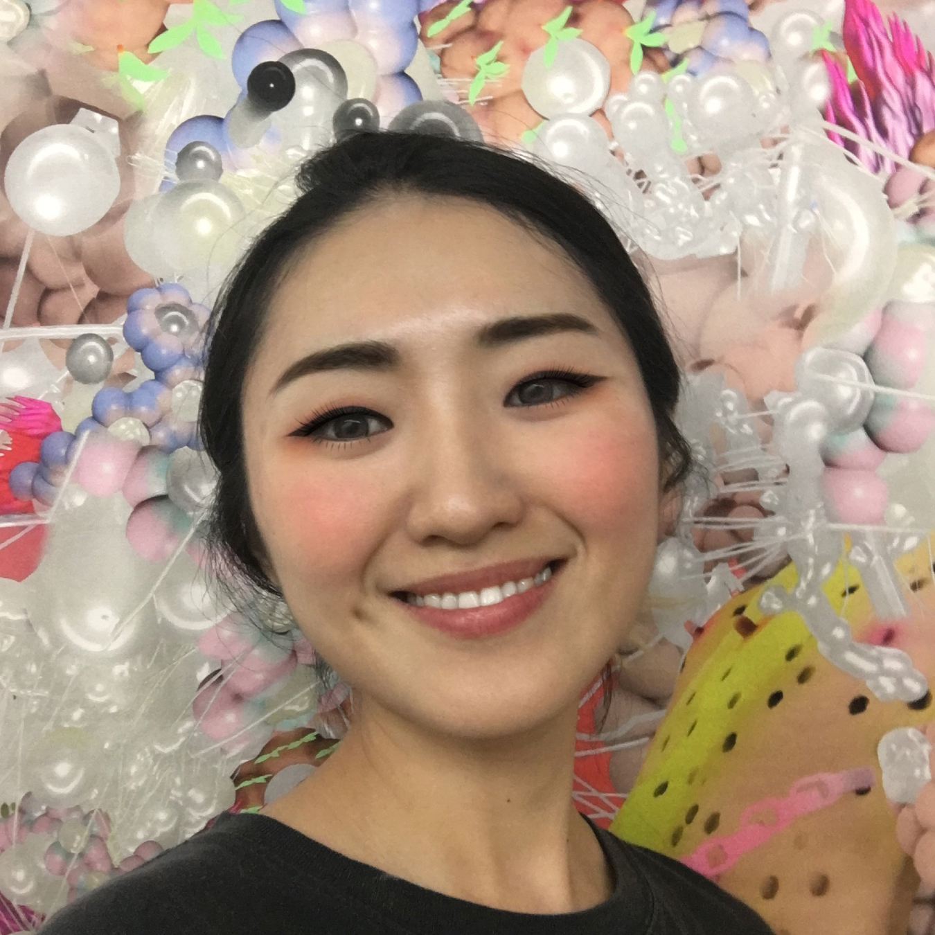 A portrait of a person against a multi-colored background.