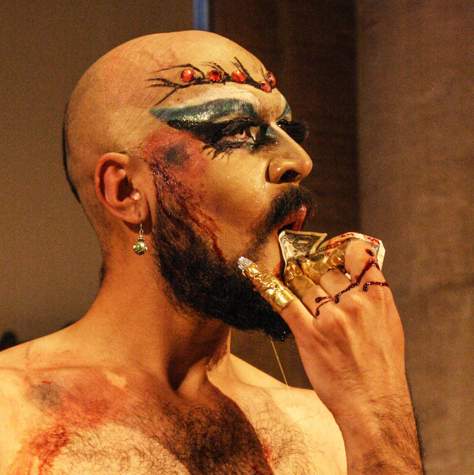 A person holding a dollar bill to their mouth.