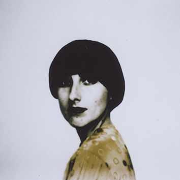 A portrait of a person against a white background.