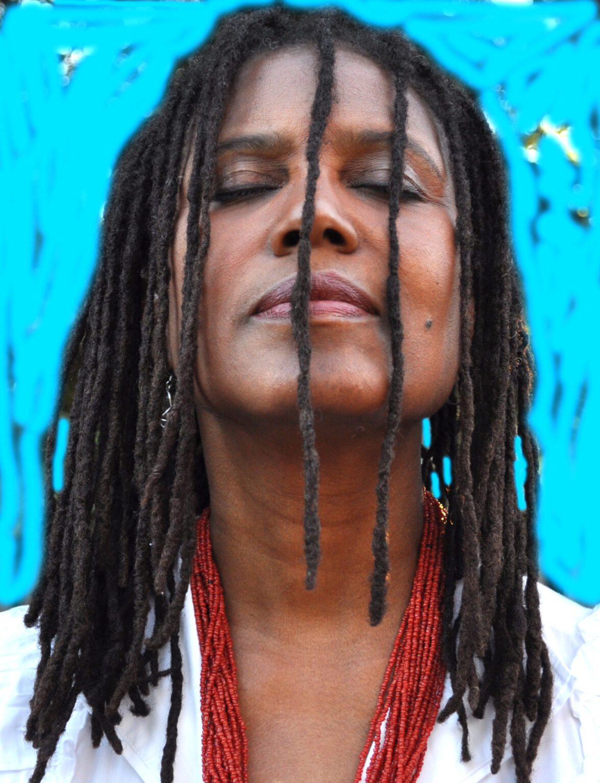 A portrait of a person against a blue background.