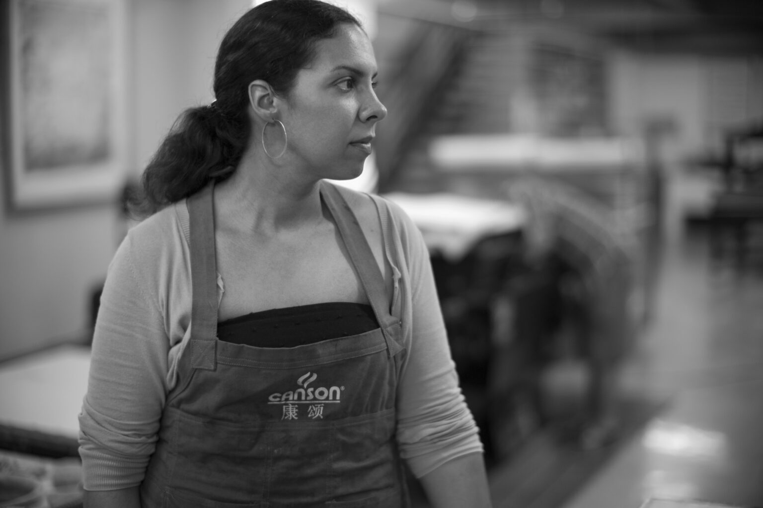 A portrait of a person in a workshop.