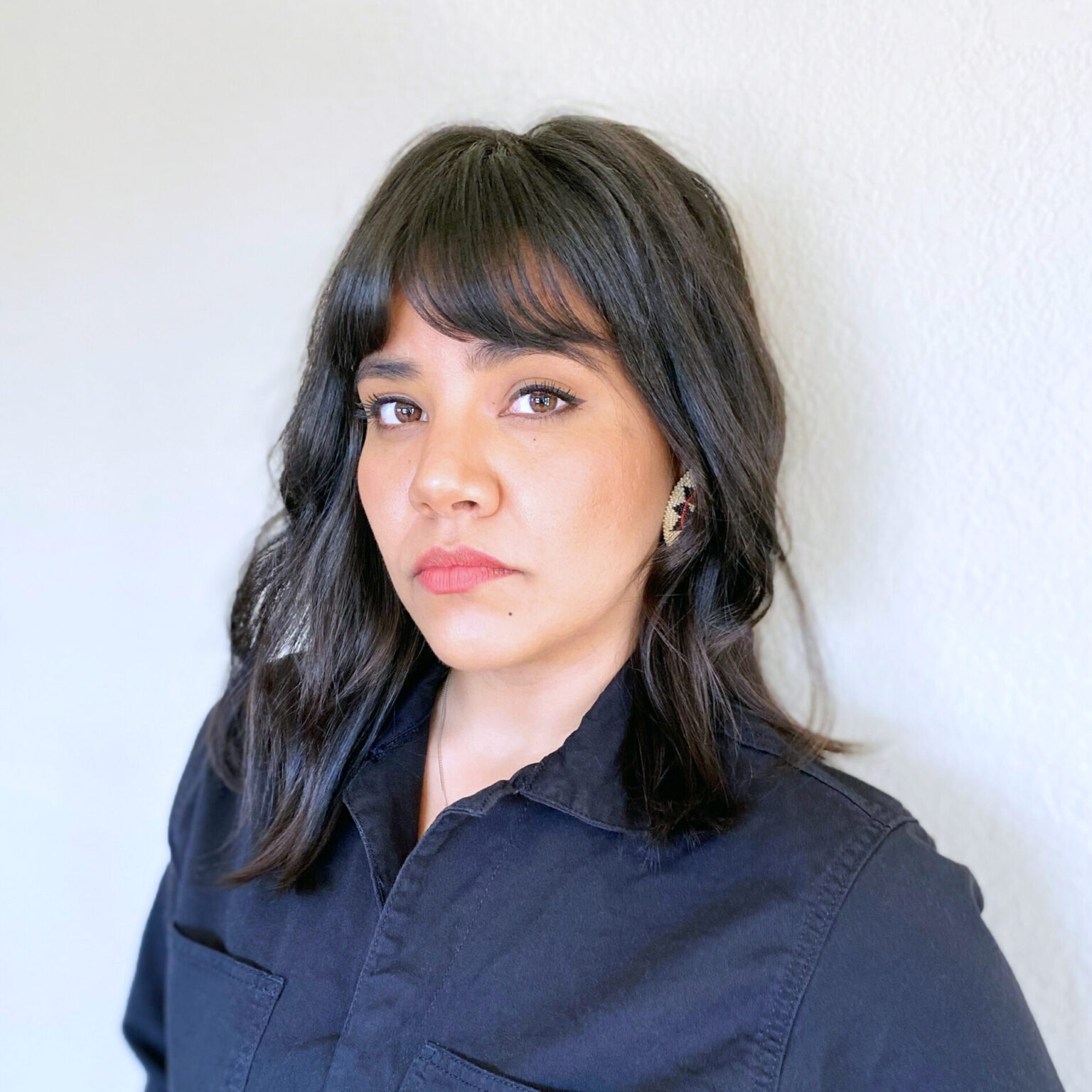 A portrait of a person against a light background.
