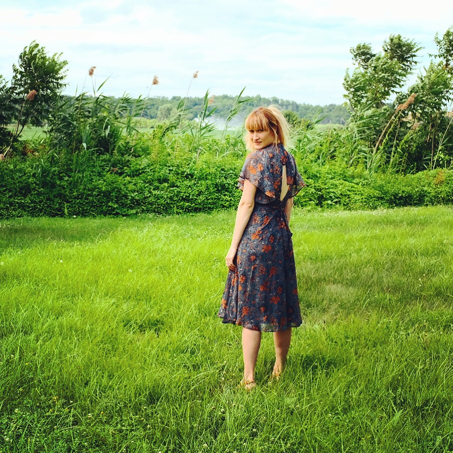 A person standing in a grassy landscape.