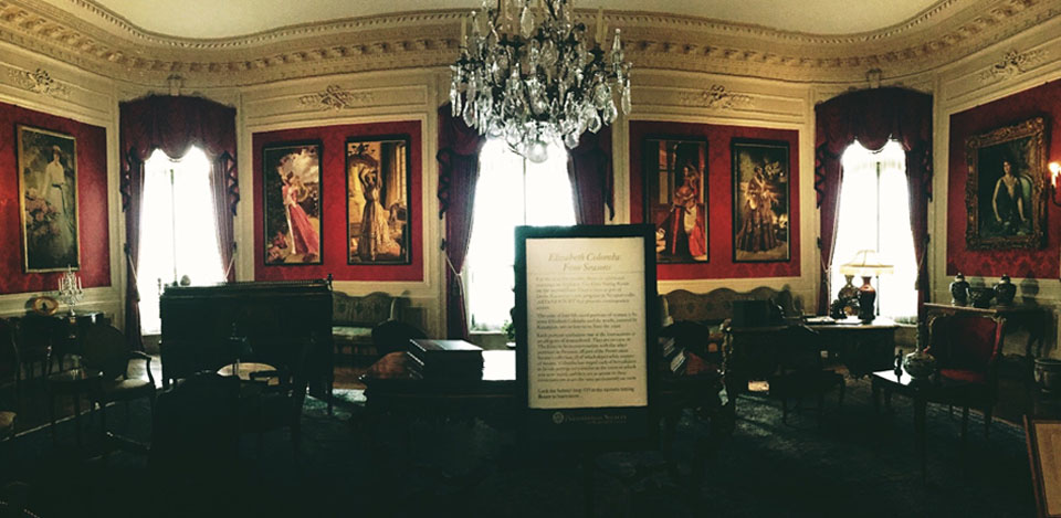 An historical room with paintings on the wall.