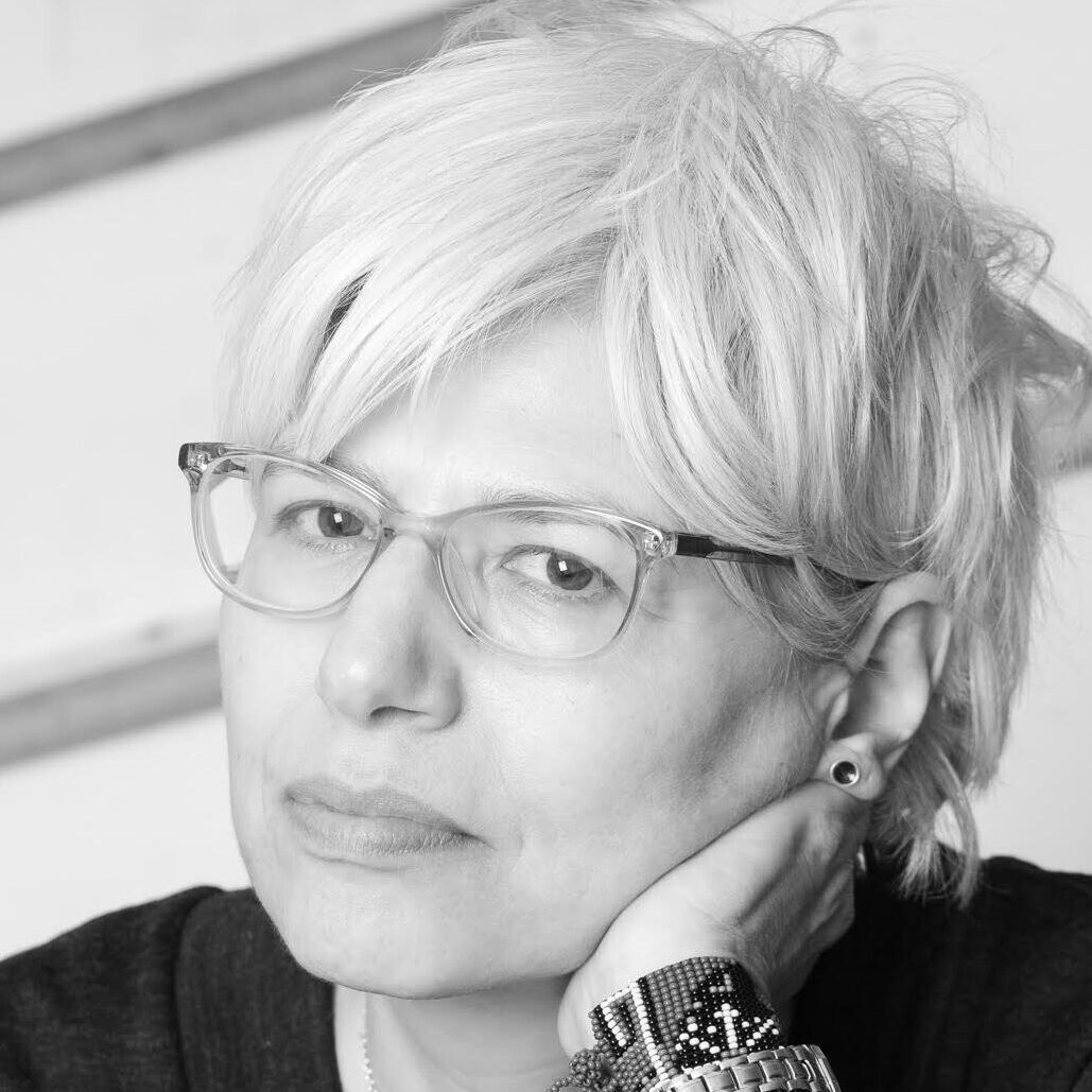 A portrait of a person against a light background.