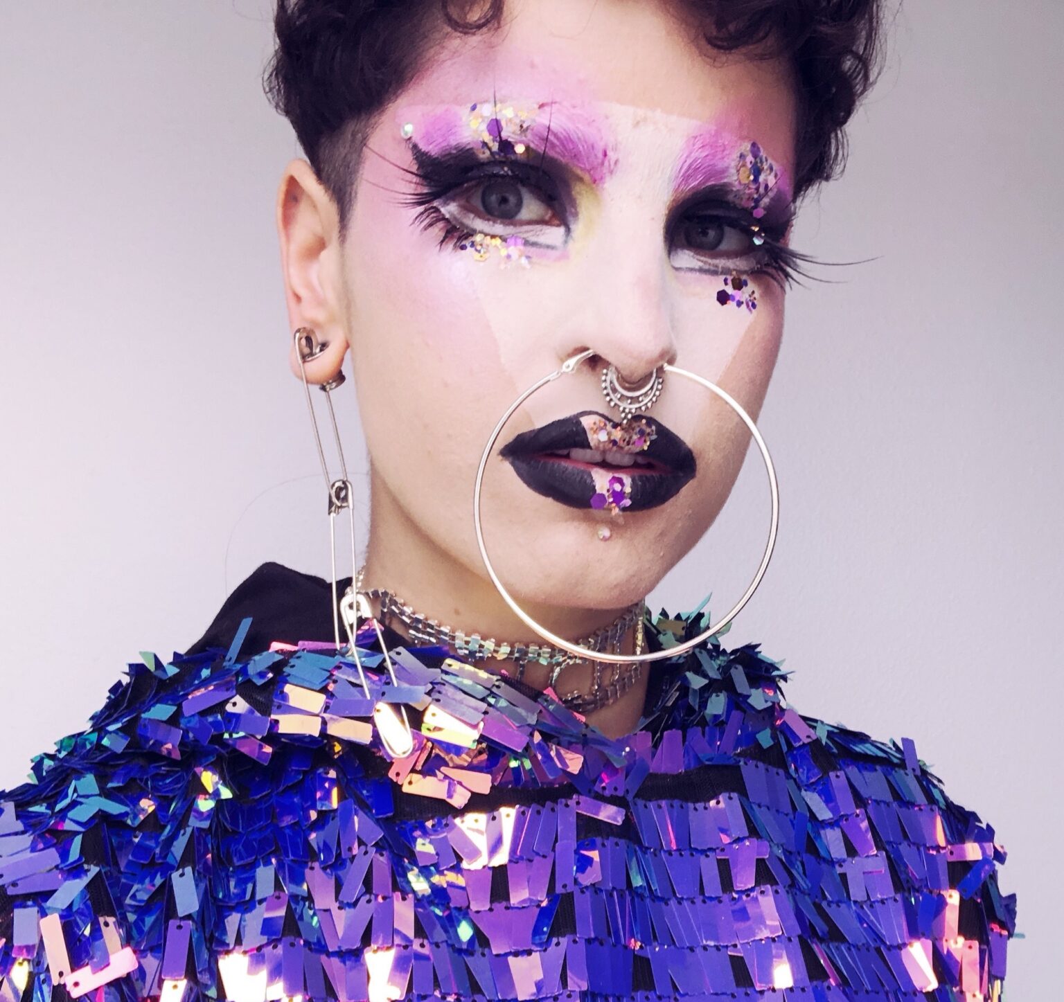 A portrait of a person against a light background.