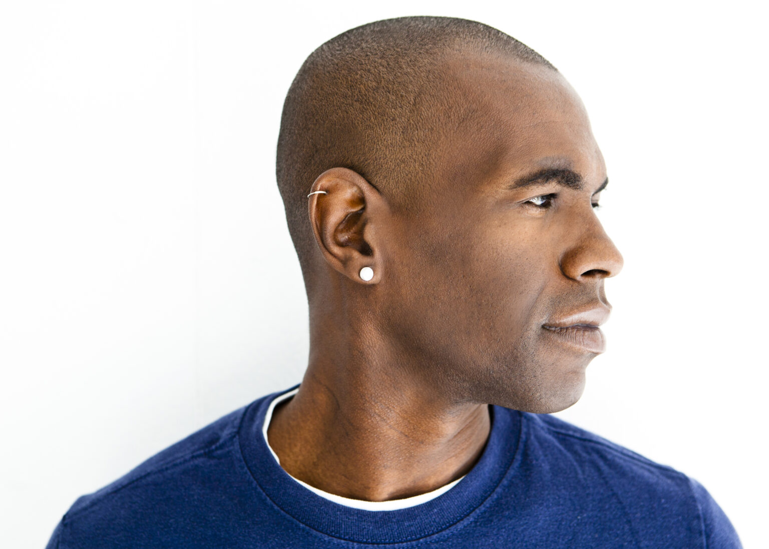 A portrait of a person against a white background.