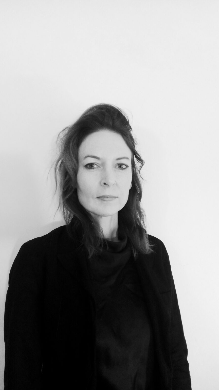 A portrait of a person against a light background.