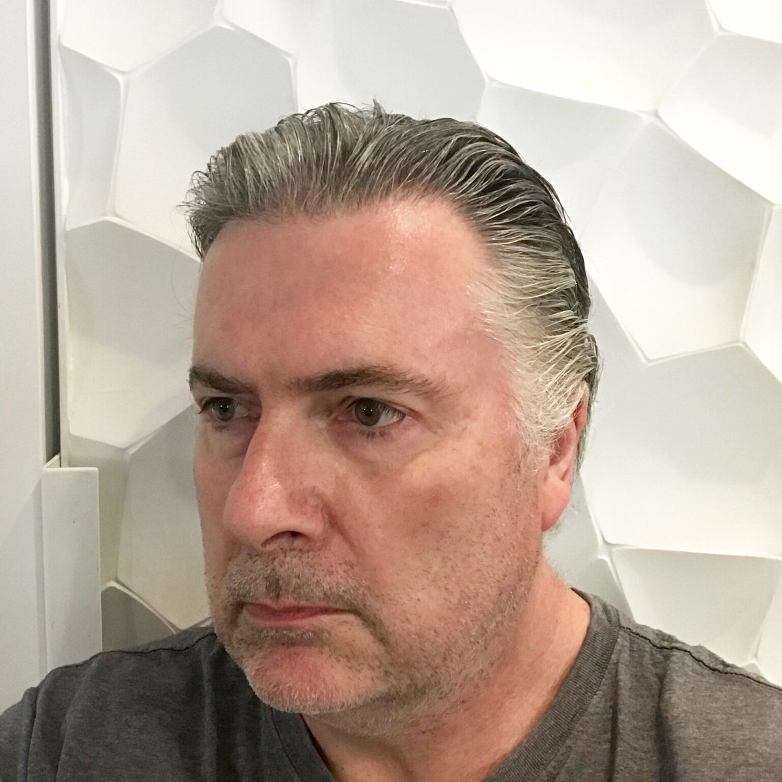 A portrait of a person against a light background.