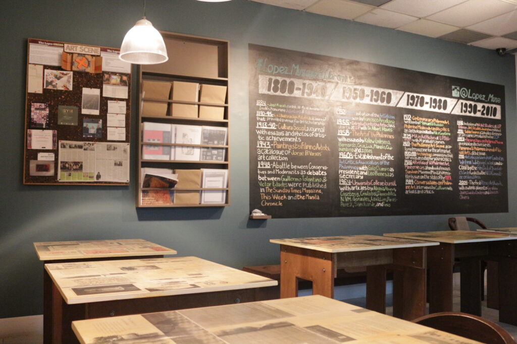 An installation with chalkboard and tables.