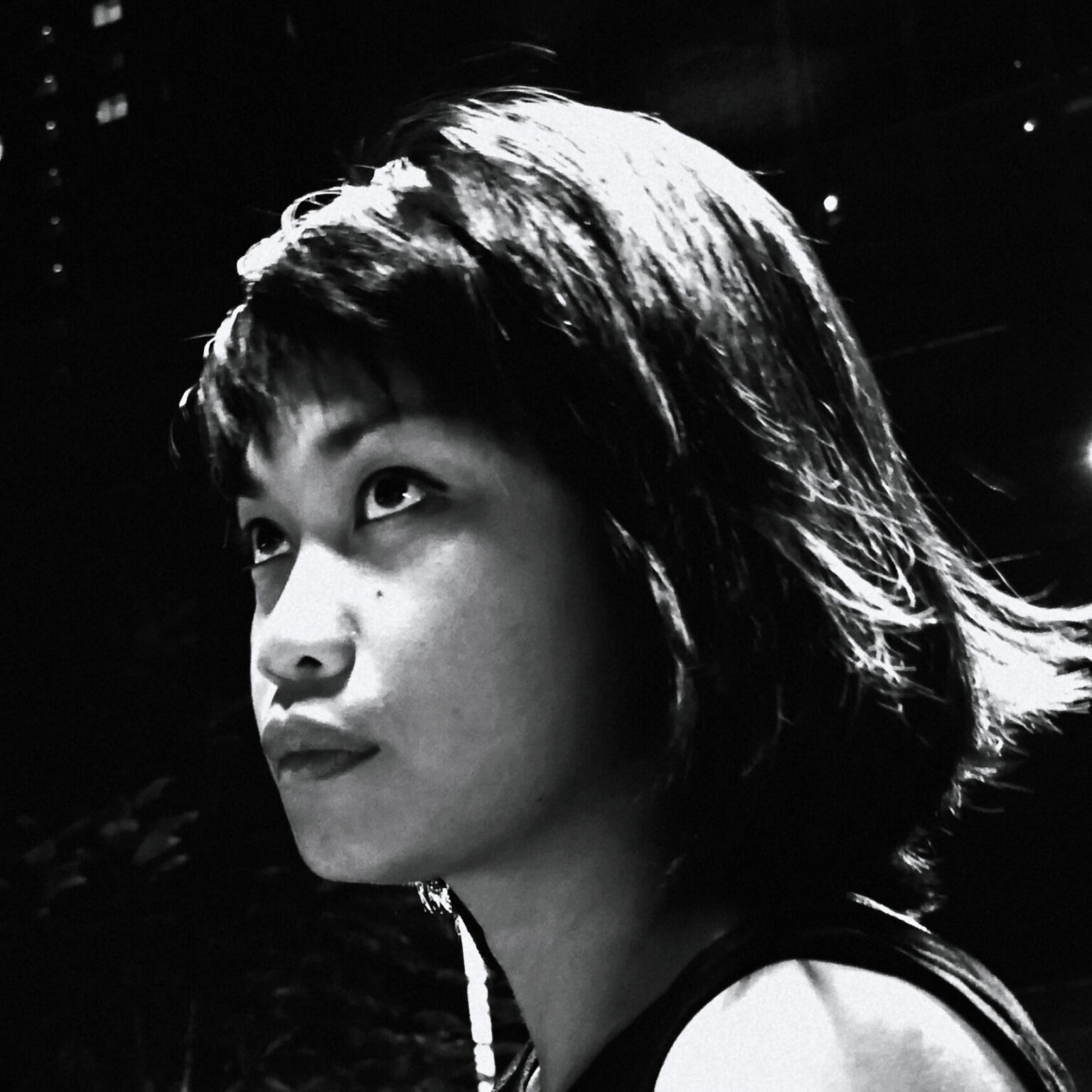 A portrait of a person against a black background.