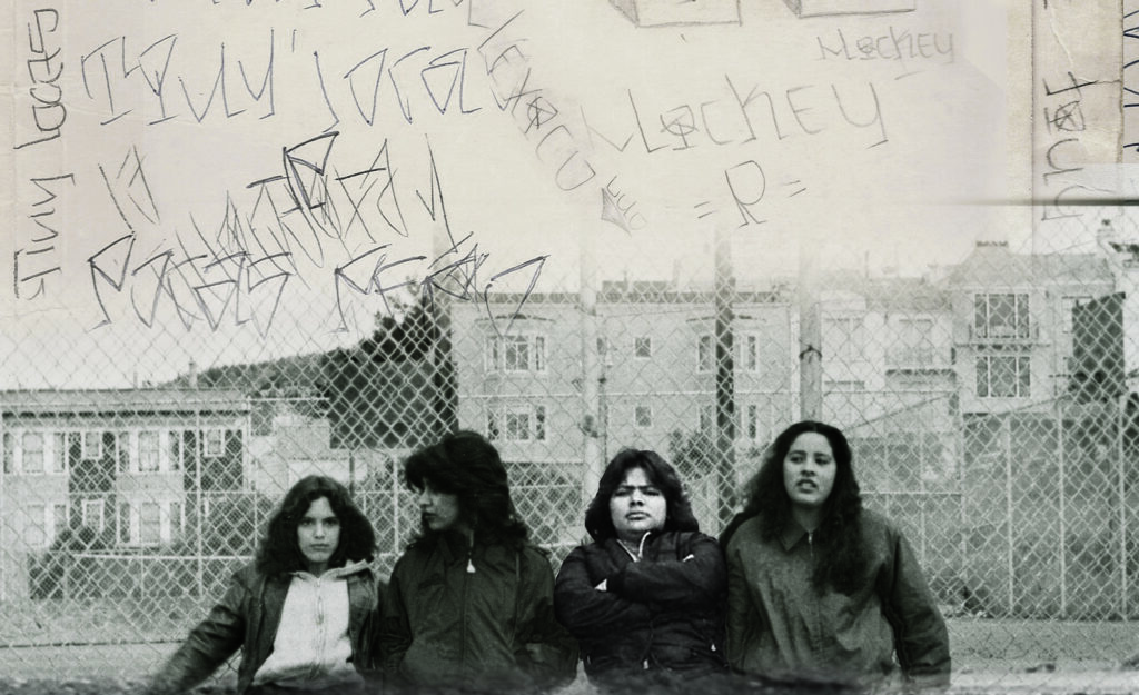 An image of four people in front of a chain-link fence with the sky above overlaid with writing.