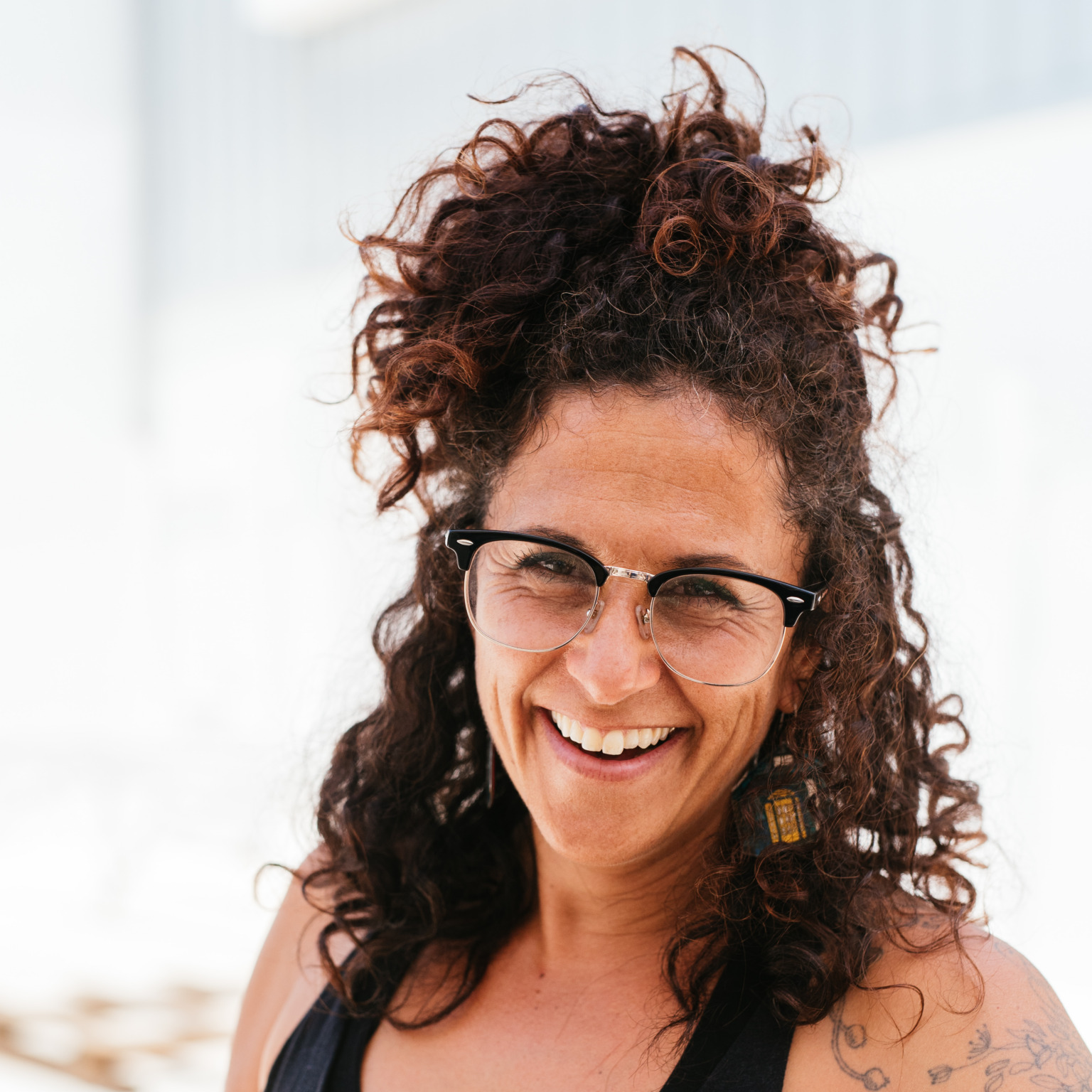 A portrait of a person holding a welding helmet.