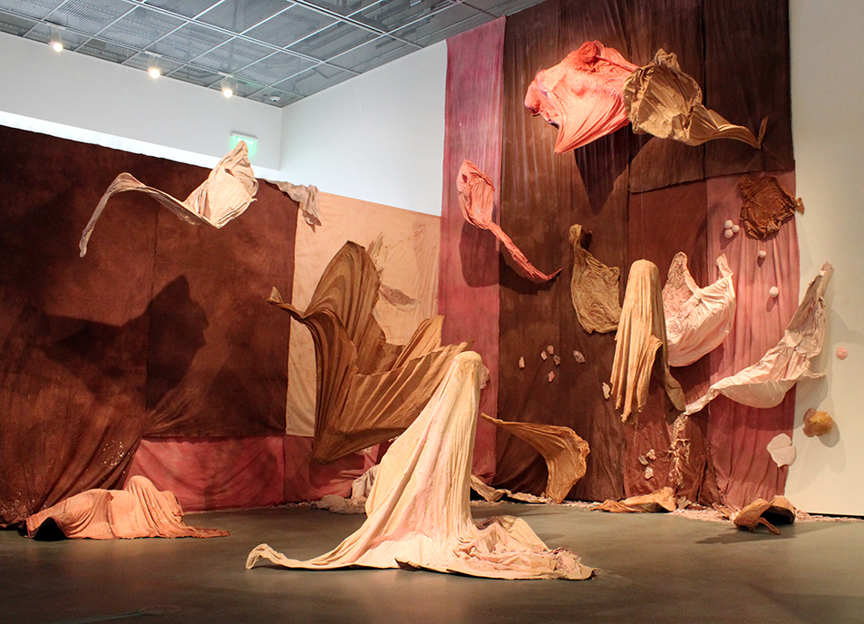 An art installation with material in the shape of humans.